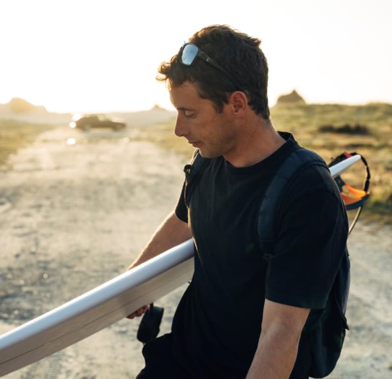 Dawn walk, board in hand